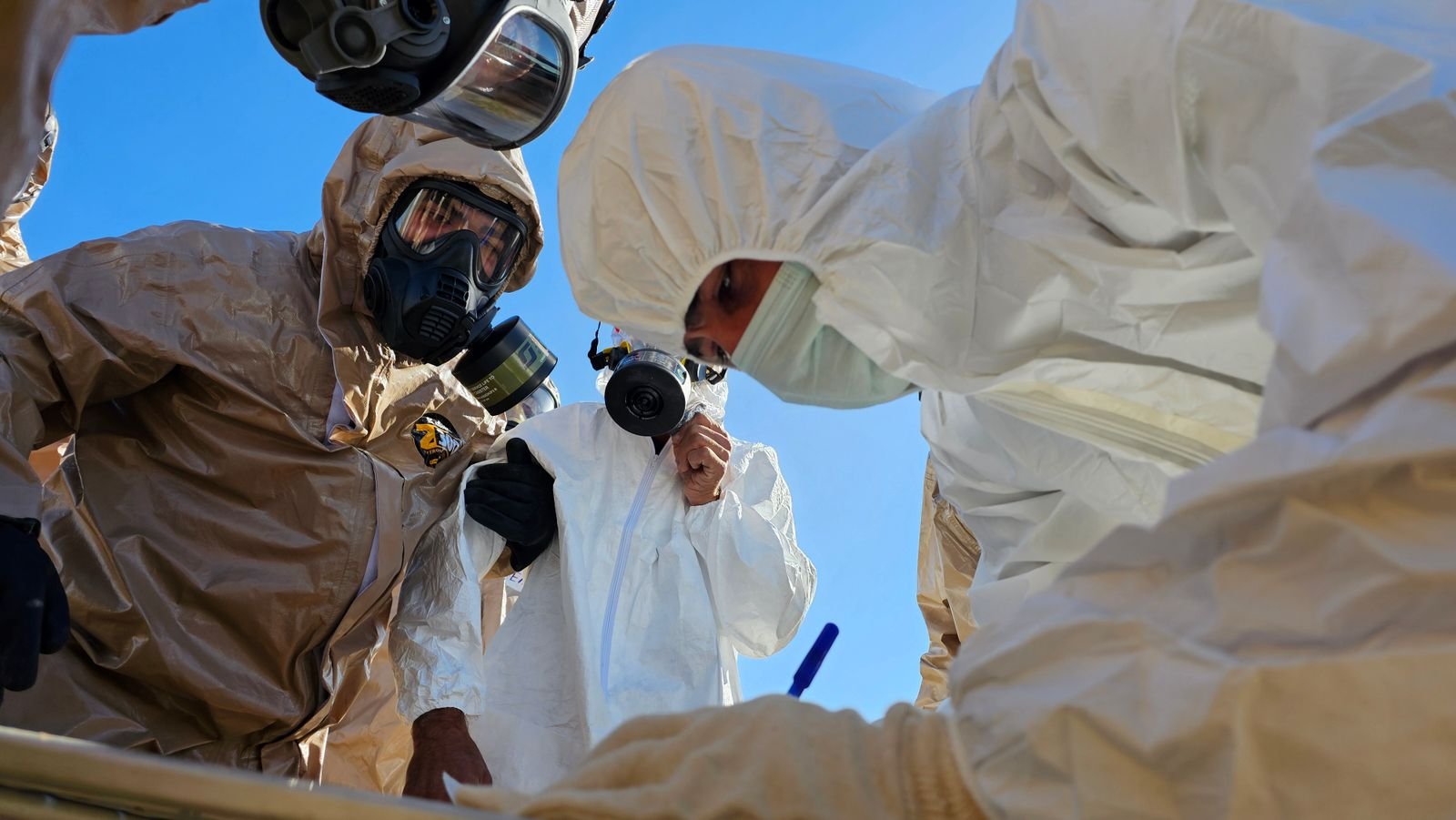 فنيون بملابس الحماية أثناء فحص الموقع